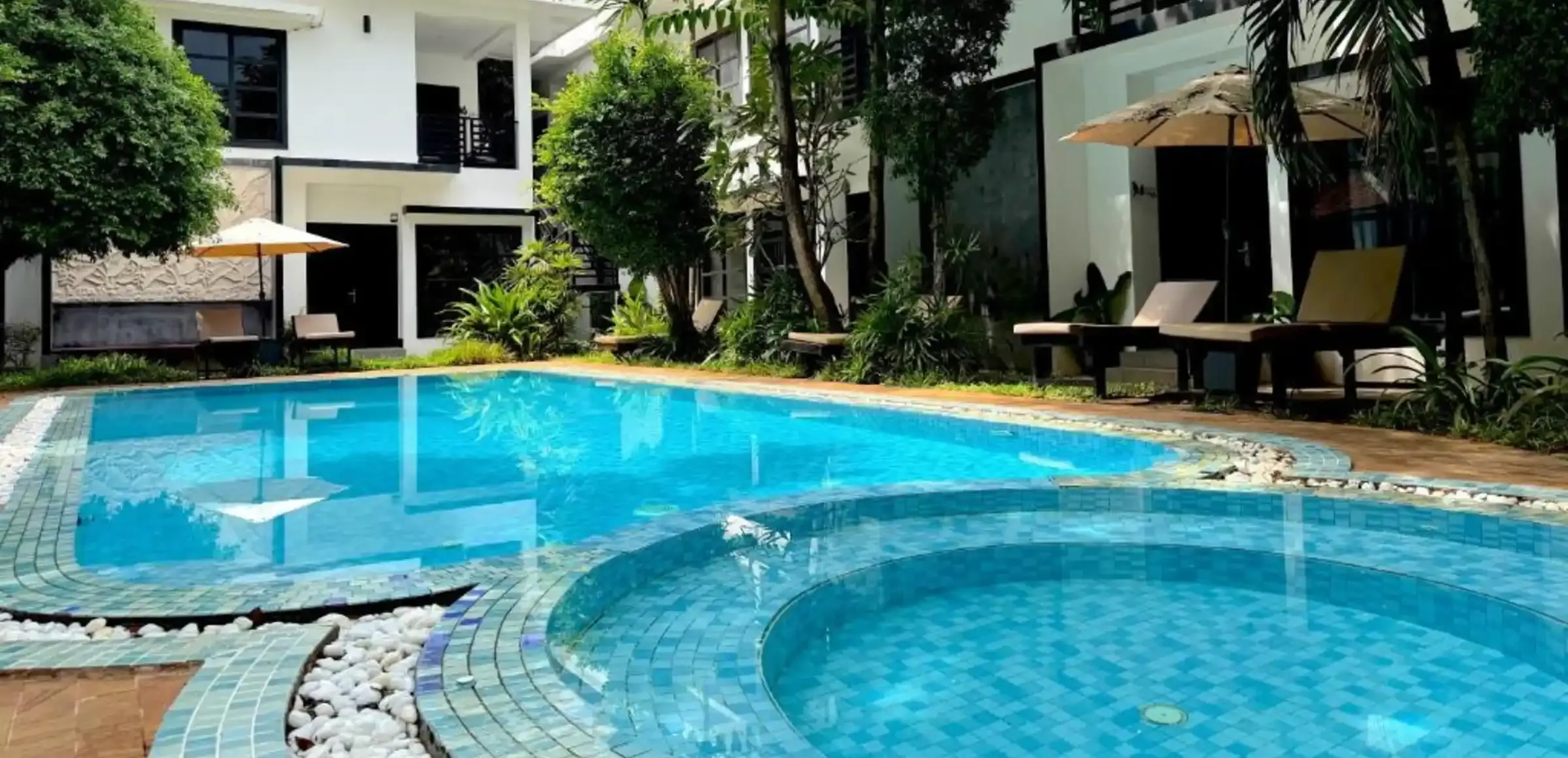 The lit pool at Prana Hotel at dusk, in Siem Reap