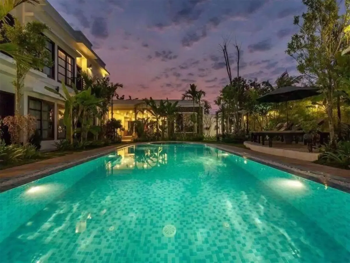 The Prana Hotel pool lit up in the evening, in Siem Reap
