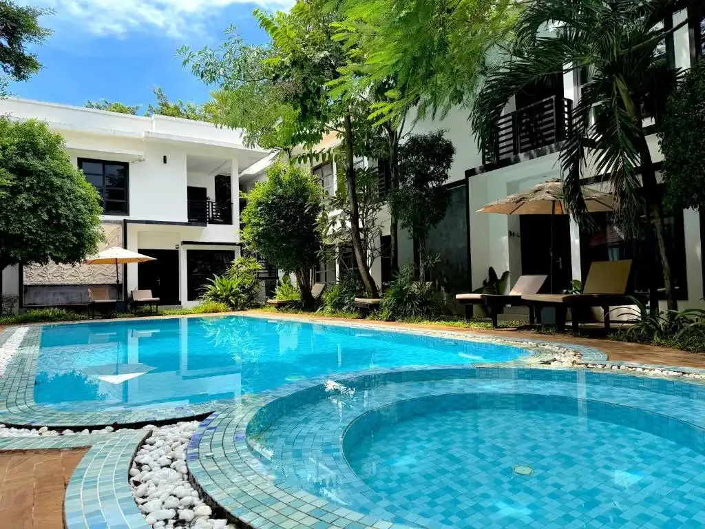 Prana Hotel pool by day, surrounded by a tropical garden